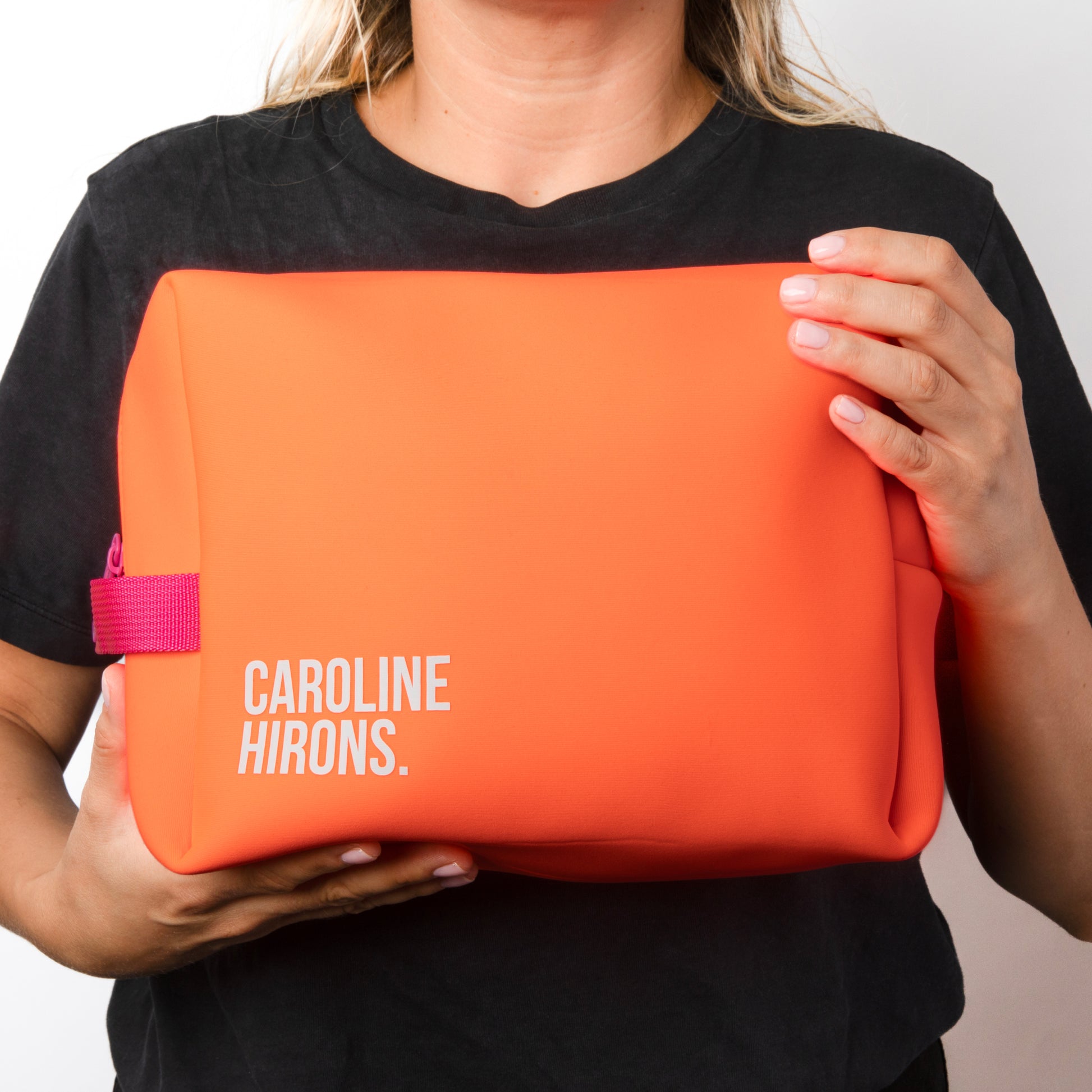 Model holding The Neon Orange Kit Bag | Caroline Hirons